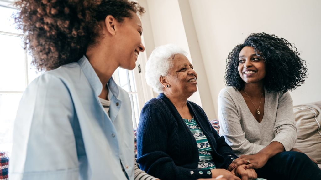 two daughters with their elderly mother