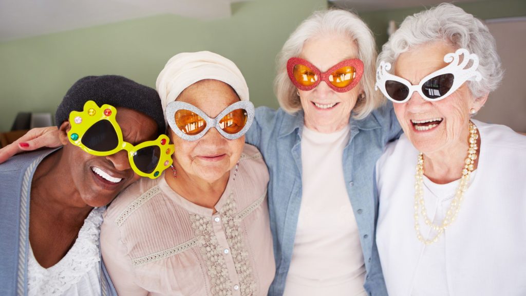 4 older ladys socializing but being silly