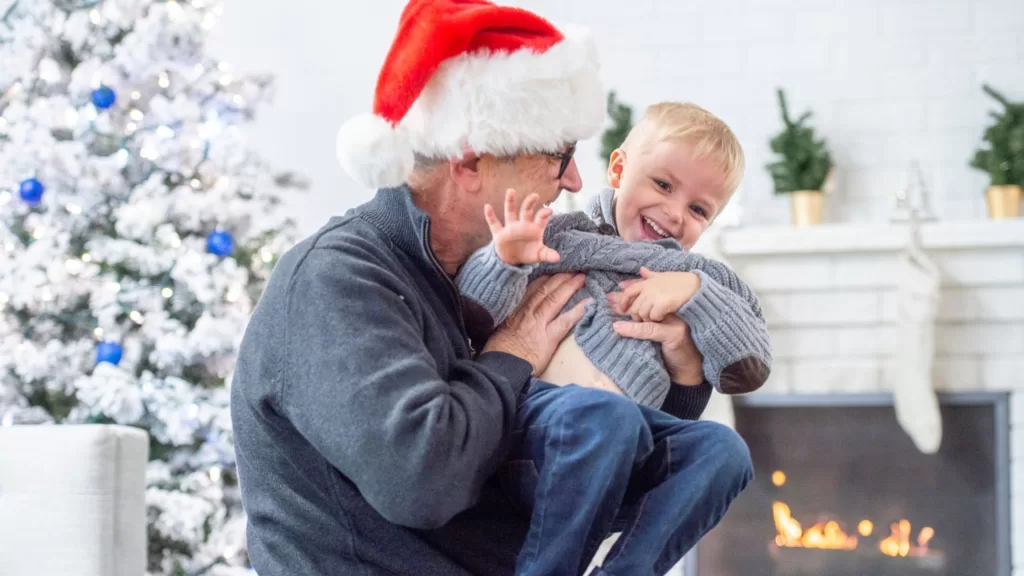 Grandpa and Baby Grandson Cherishing Christmas Moments Together at Home