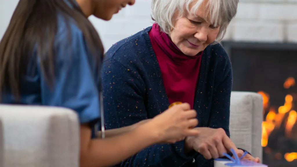 elderly woman sorting medication with her carer