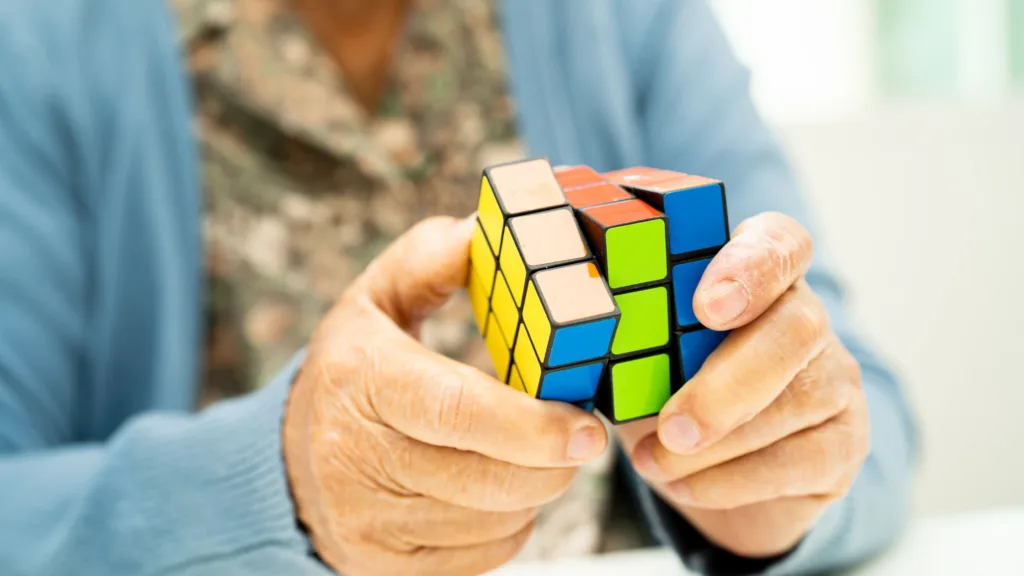 an elderly woman with a rubix cube